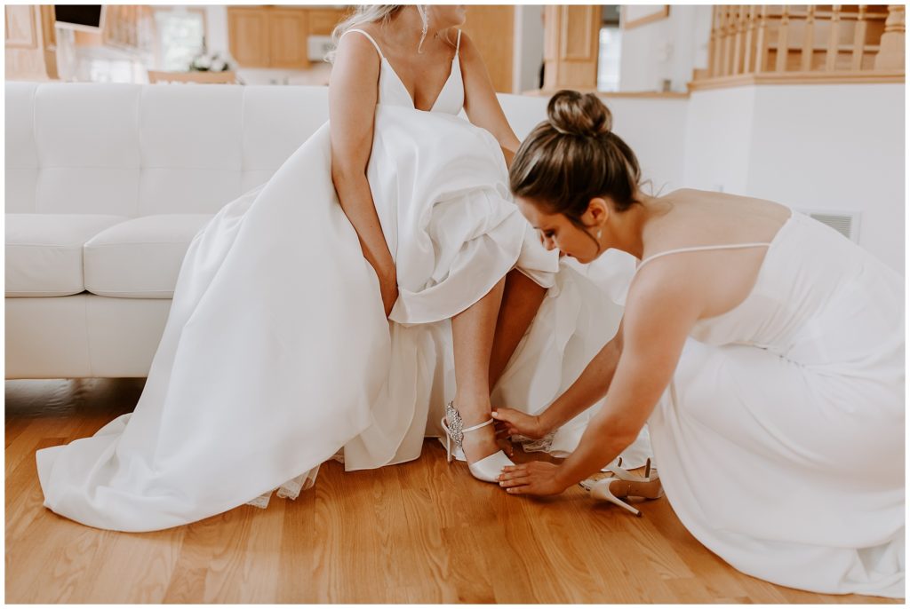 bride and bridesmaid getting ready